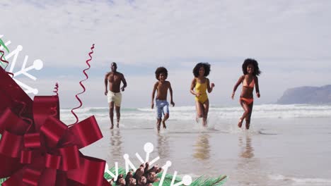 animation of red bow over happy african american family running on beach