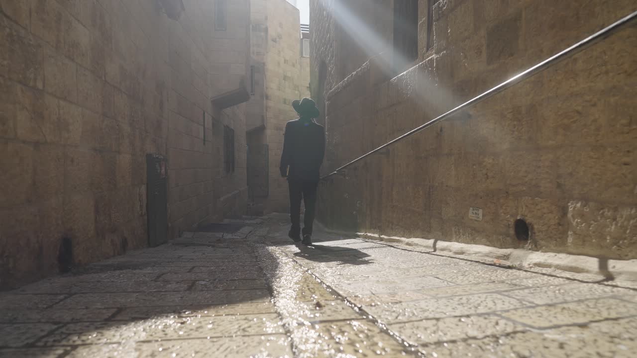 Man Walking Through the Narrow Streets of Jerusalem's Old City