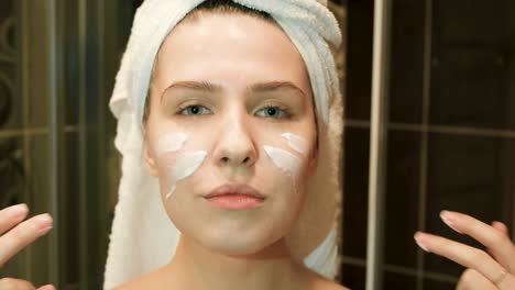 woman applying facial cream