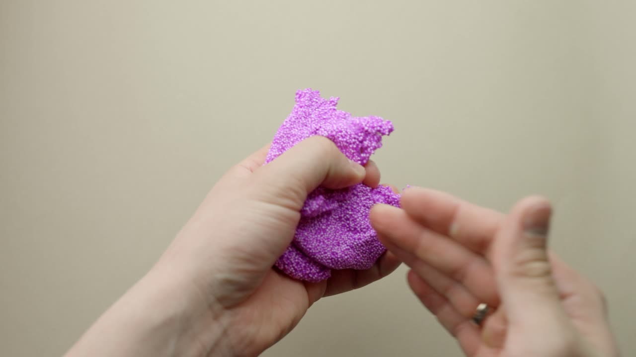 Relax therapy - purple slime with glitter in person hands, POV