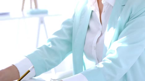 businesswoman calculating at her desk