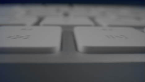 White-buttons-on-computer-keyboard-in-detail.-Modern-white-keyboard-on-table