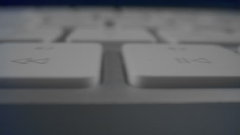 white buttons on computer keyboard in detail. modern white keyboard on table