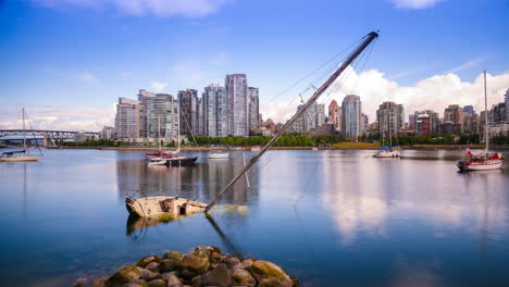 timelapse of sunken boat in harbour with modern city in the background