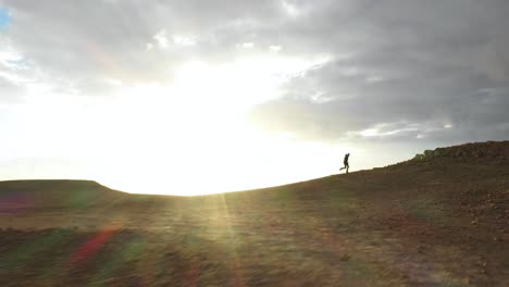 determination concept - man running uphill in negev desert, aerial