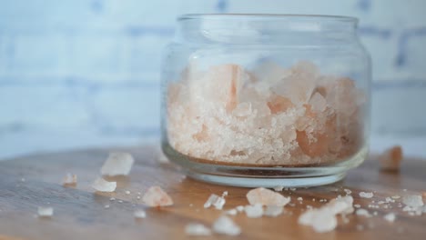 close up of pink rock salt in a bowl on table