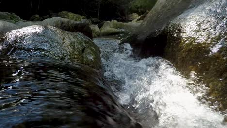 slow motion view of water flowing over rocks at stoney creek