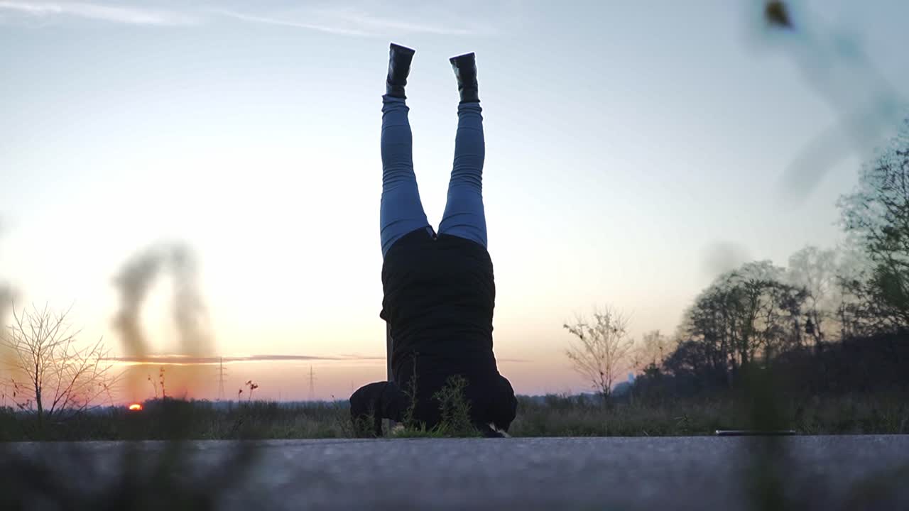 silhouette of a girl  doing a handstand