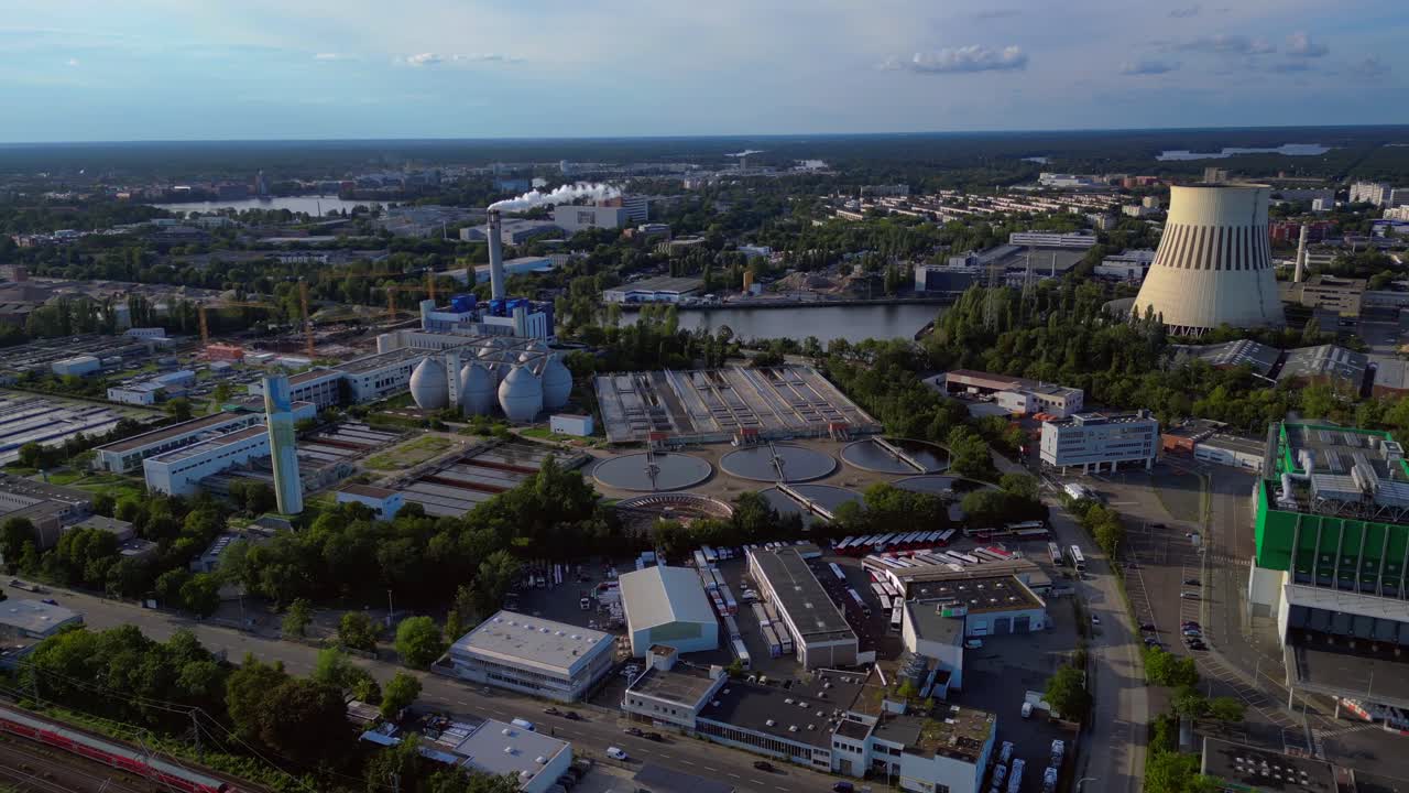 sewage treatment plant in Berlin, featuring circular clarifiers, anaerobic digesters, and other wastewater processing infrastructure. panorama orbit drone