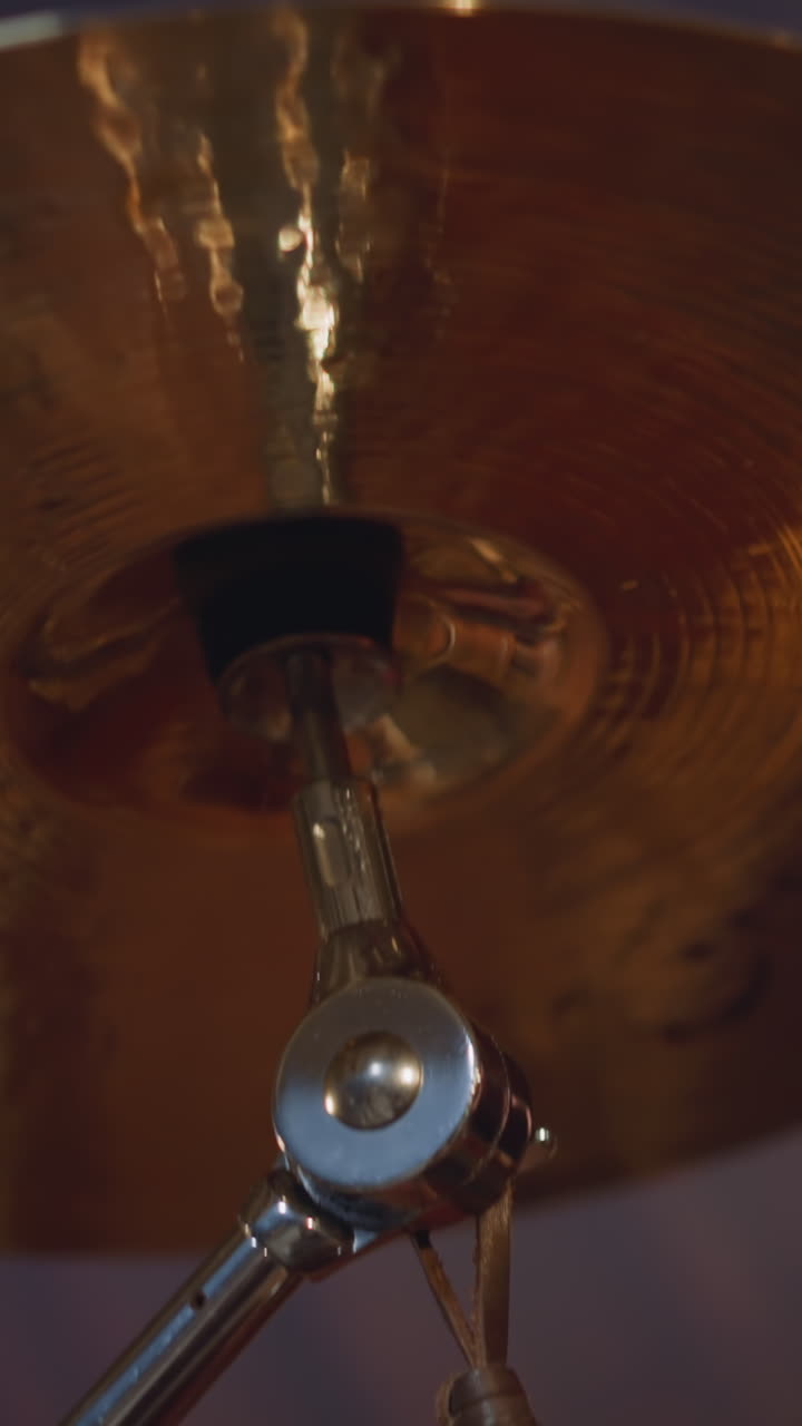 Professional musician plays drums performing with folk rock band focus on brass cymbal. Altai ethnic musical show. Instruments on stage