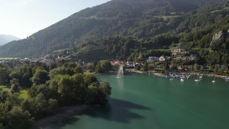 Static-aerial-view-of-beautiful-mountain-lake-and-village-in-Switzerland