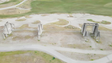 AERIAL-DRONE-SHOT-OF-STRANGE-CONCRETE-STRUCTURES-NEAR-GOLF-COURSE-IN-TACOMA