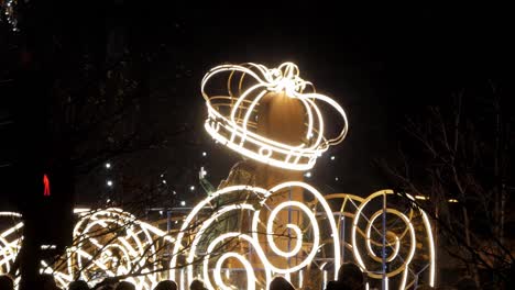 a close-up view of the illuminated carousel float from the three kings parade (cabalgata de reyes), filling the frame as it moves forward and eventually shows the back side as it drives away.