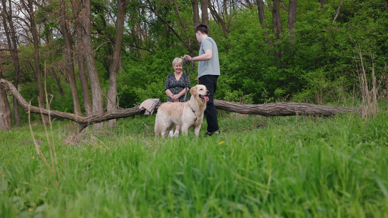 Grandparent and Grandchild Enjoying a Walk with their Dog in the Forest