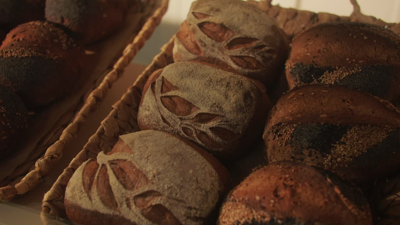 Fresh artesian bread on bakery shop close-up. Bread with black poppy garnish on top and white flour on top. Artisan bread is making by skill bakers using natural and high-quality ingredients. Food with health and flavour benefits.