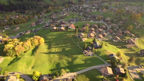 aerial drone footage pushing in grindelwald, autumn sunset colors