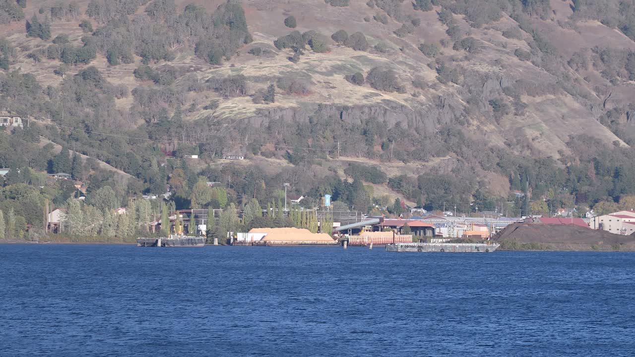 Sawmill industrial buildings and sawdust piles, Columbia River, Hood River, USA