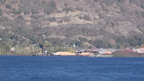 sawmill industrial buildings and sawdust piles, columbia river, hood river, usa