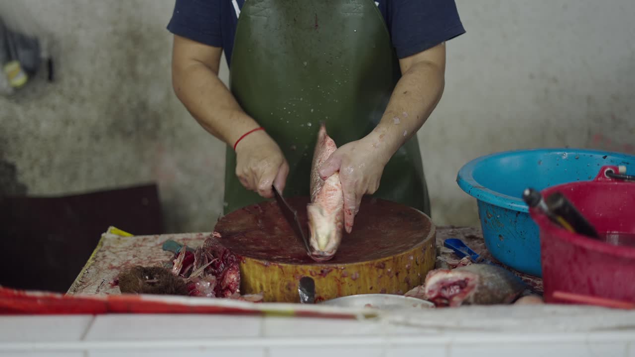 Fishmongers Cutting Fish at a Market