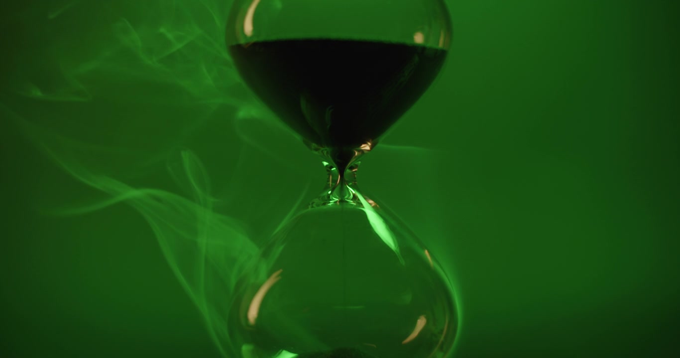 Hour glass on green background