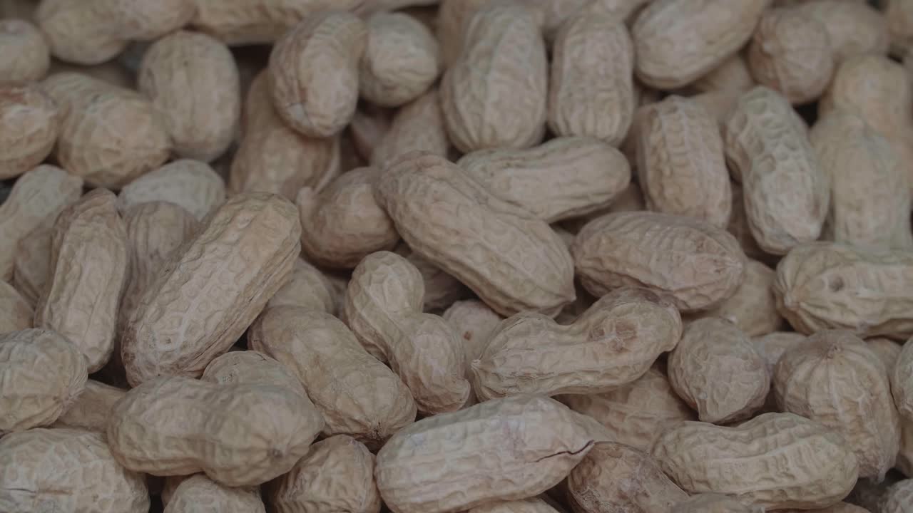 Rotation Of Peanuts Close Up. They'Re A Convenient Source Of Protein And Come With The Added Bonus Of Healthful Nutrients