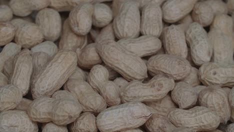 rotation of peanuts close up. they're a convenient source of protein and come with the added bonus of healthful nutrients