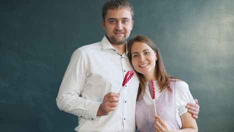 couple holding lollipops