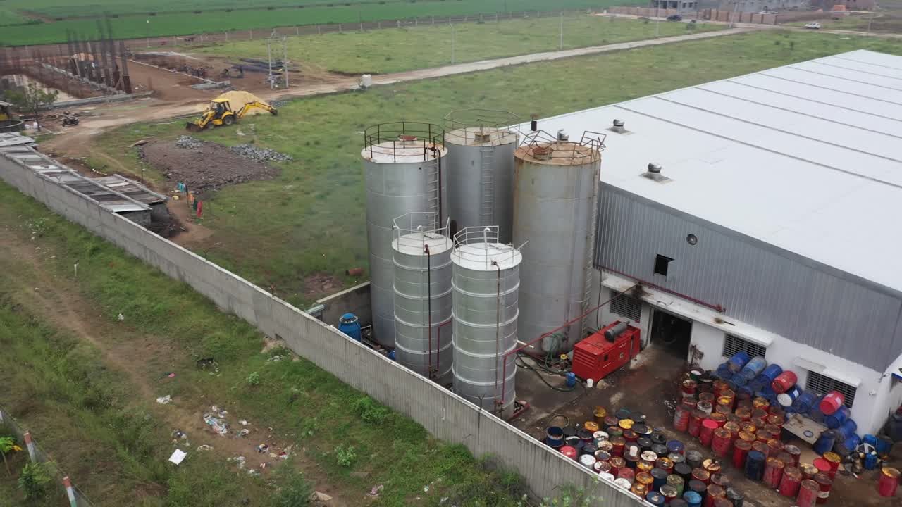 aerial drone view big grease storage tank, industry 5.0