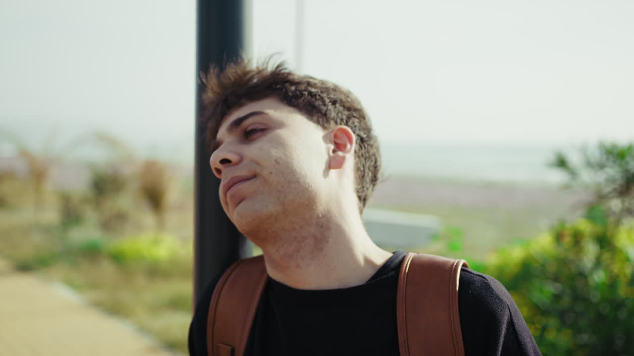 Tired Man Looking For Someone To Arrive On The Sidewalk Near The Sea