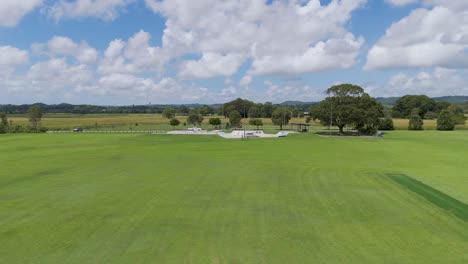 expansive green field with skate park