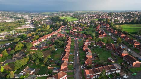 Yorkshire's-cityscape:-Aerial-drone-footage-of-council-housing-with-red-brick-exteriors,-under-the-warm-morning-sun,-and-residents-going-about-their-routines