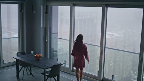 relaxed model stepping kitchen looking window high angle view. woman morning