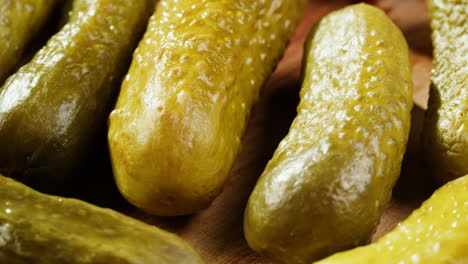 close-up of pickled cucumbers on wooden board