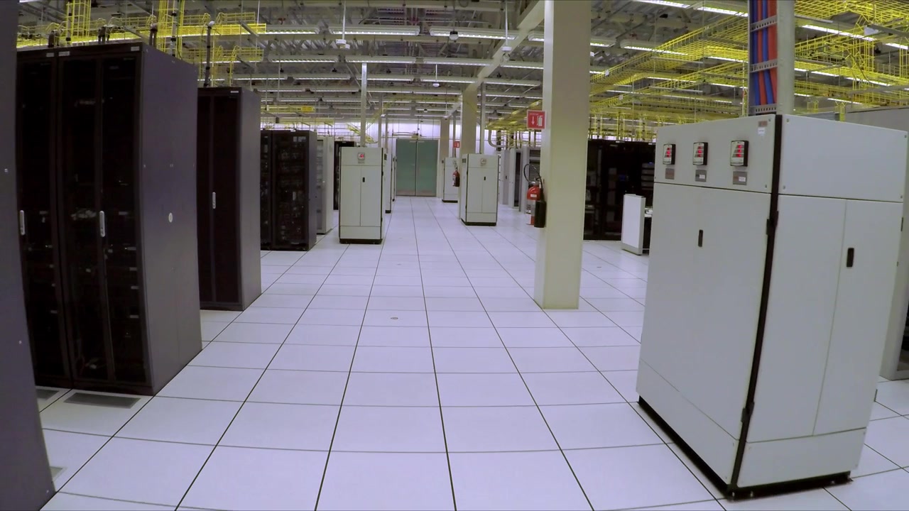 Interior of modern data center with server racks, network equipment and technicians working in large technology facility environment