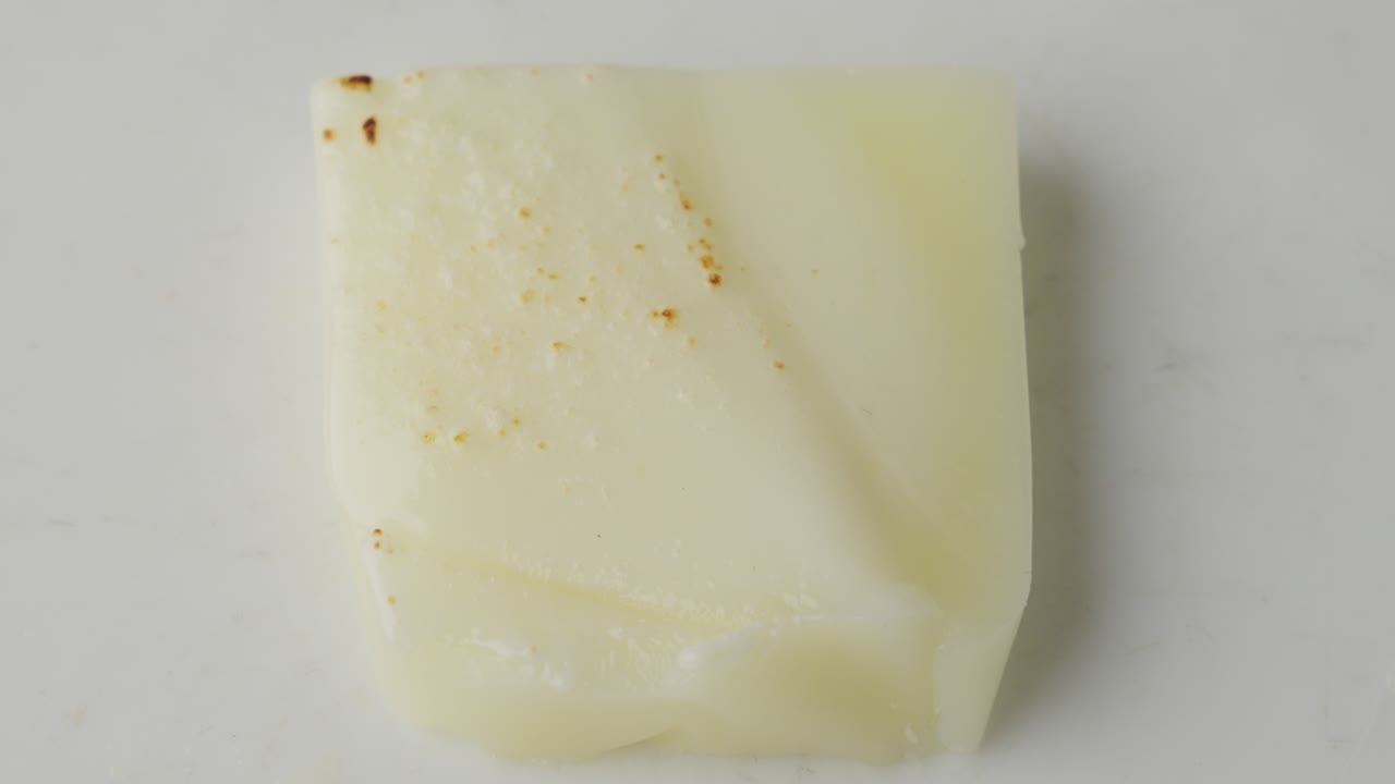 Mozzarella Cheese Slice Flake Up and Burn By Blowtorch Flame, Close Up Top Down