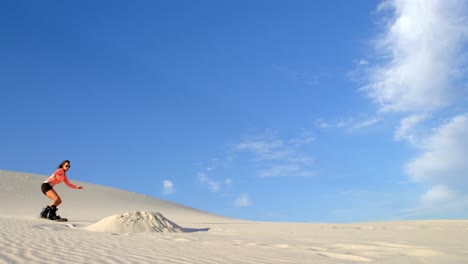 woman performing a jump while sand boarding 4k