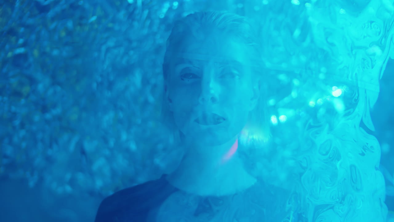 Creative Portrait of Woman with Goth Makeup in Liquid Sky Laser Light