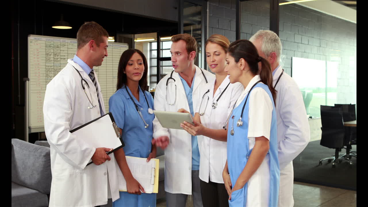 Doctors using tablet and talking