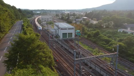 Toma-Aérea-Del-Hokuriku-Shinkansen-Saliendo-De-La-Estación-De-Karuizawa-Hacia-Tokio