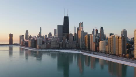 chicago skyline reflecting in lake michigan on clear winter day