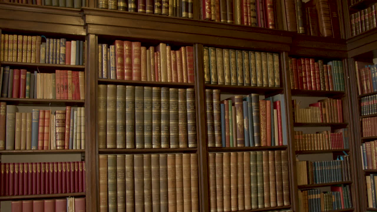 Tilt down over old books in luxurious private library