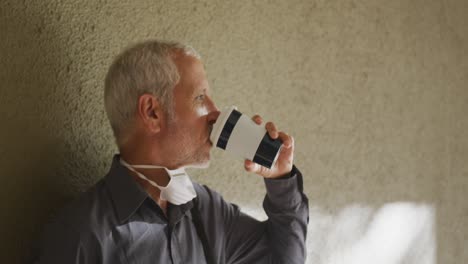 Caucasian-man-out-and-about-in-the-street-wearing-on-a-face-mask-against-coronavirus