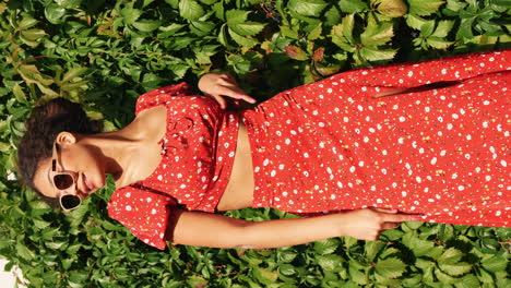 woman in red floral dress relaxing outdoors