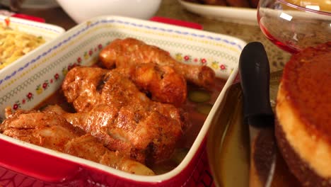 spiced chicken legs in a red dish