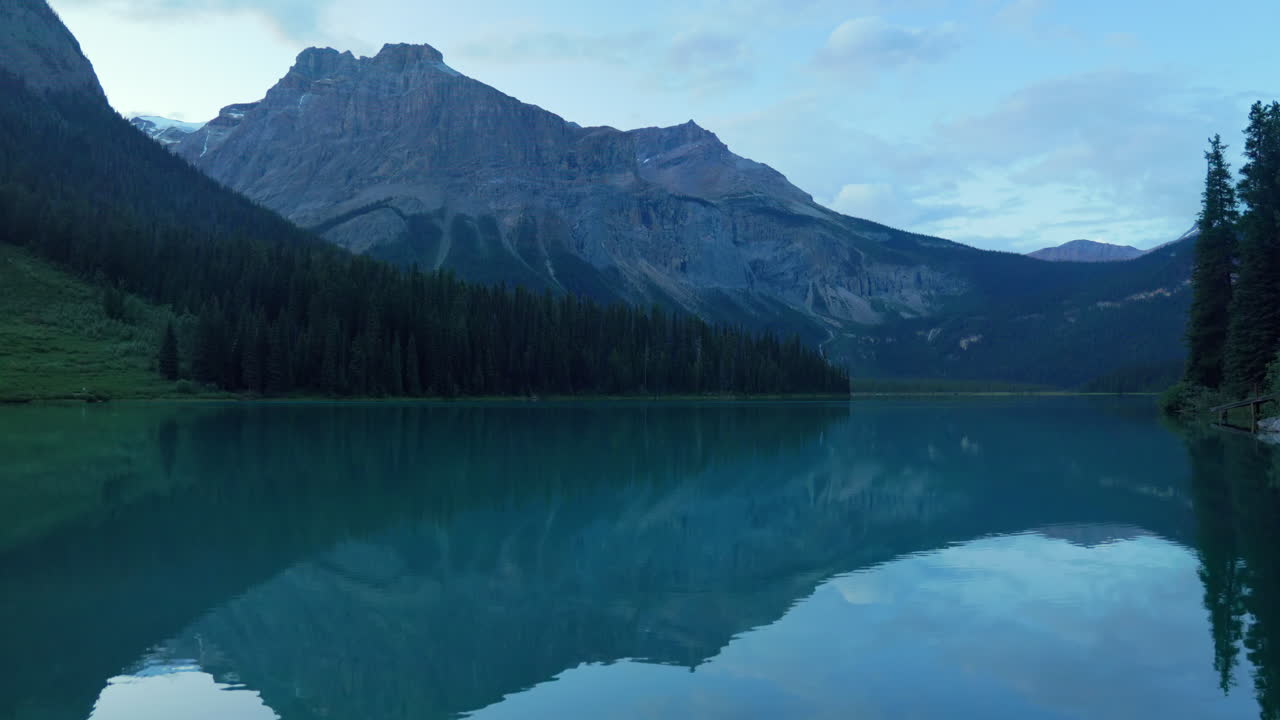 Peaceful view of Emerald Lake at dusk, with calm turquoise waters and mountain reflections