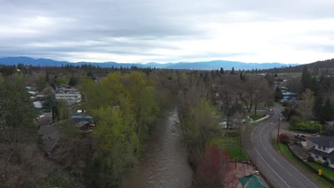 Aerial-view-of-small-town-and-creek-in-Oregon