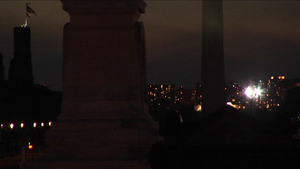 A Statue Of Ulysses S Grant Is In Silhouette In The Foreground Of The Washington Monument On A Cloudy Night