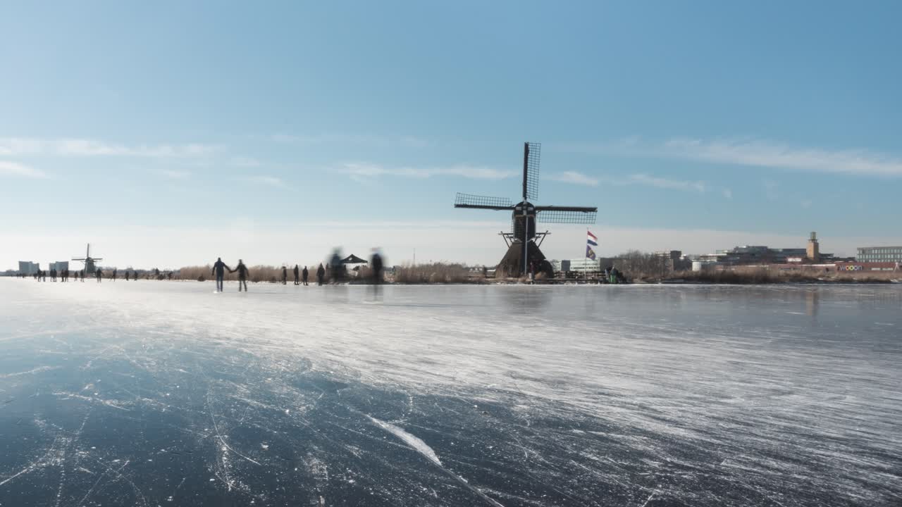 Ice skaters in Netherlands on frozen canal, beautiful winter time lapse
