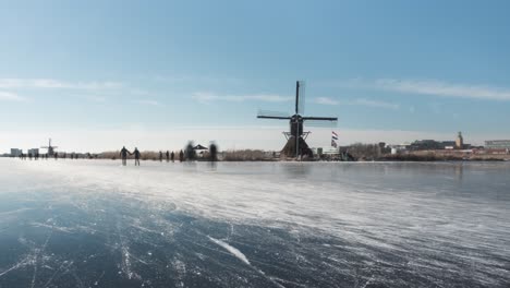 ice skaters in netherlands on frozen canal, beautiful winter time lapse