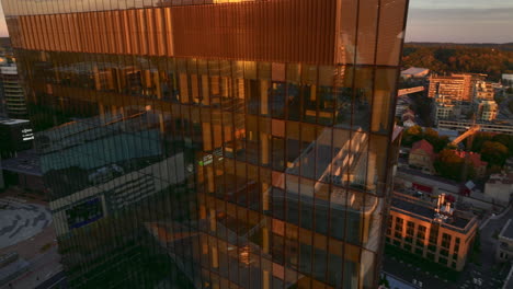 stunning aerial view of a modern glass skyscraper at sunset